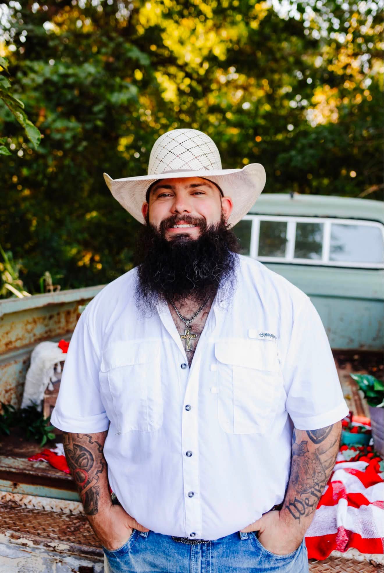 Owner of Long’s Fab & Repair wearing a white cowboy hat