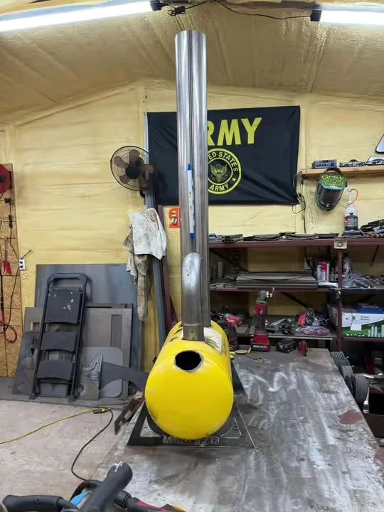 Yellow 11-gallon smudge pot with a tall metal stack on the shop workbench